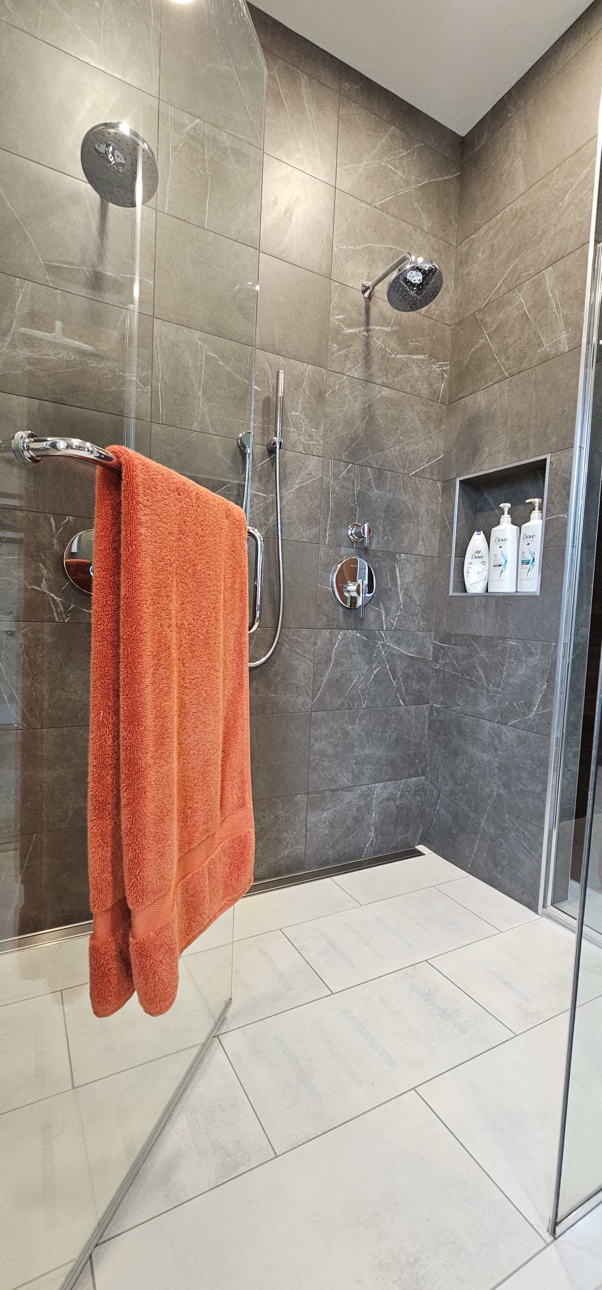 towel hanging in custom tile shower