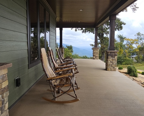 rocking chairs on front porch with view into the blue ridge mountains