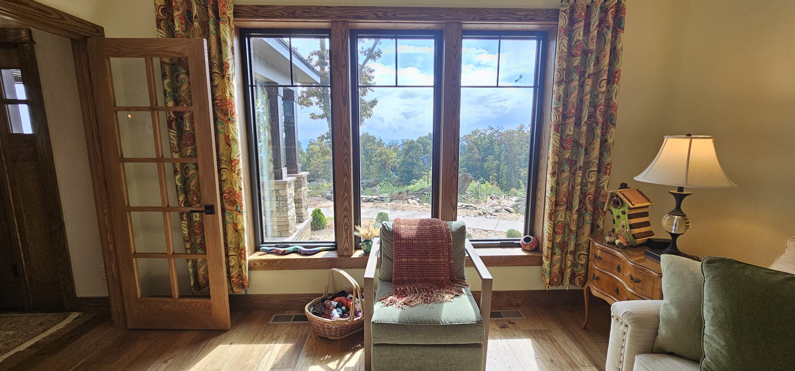 view looking out a triple window into the woods