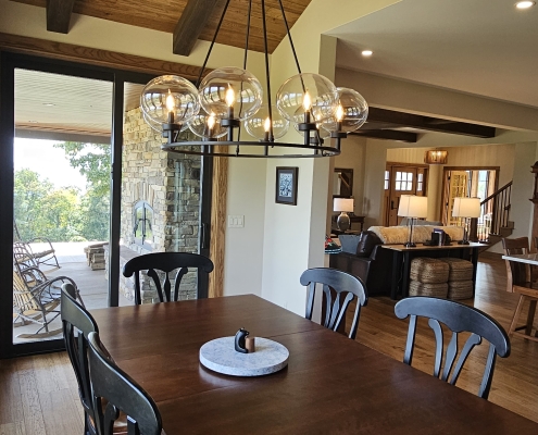 dining room with wood ceiling and kitchen in background