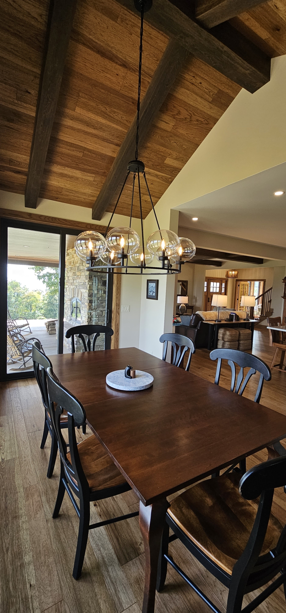 dining room with wood ceiling and kitchen in background