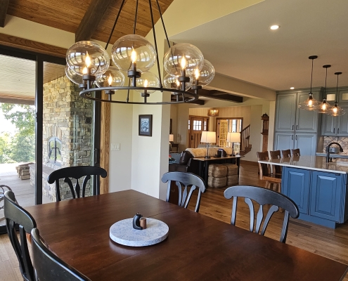 dining room with wood ceiling and kitchen in background