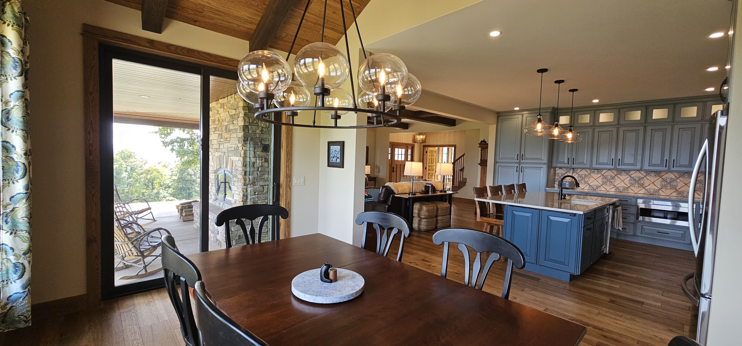 dining room with wood ceiling and kitchen in background