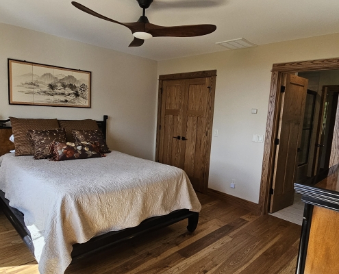 bedroom showing wood doors with craftsman style trim