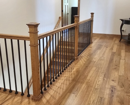 wood and metal railing around stairs descending to the first floor