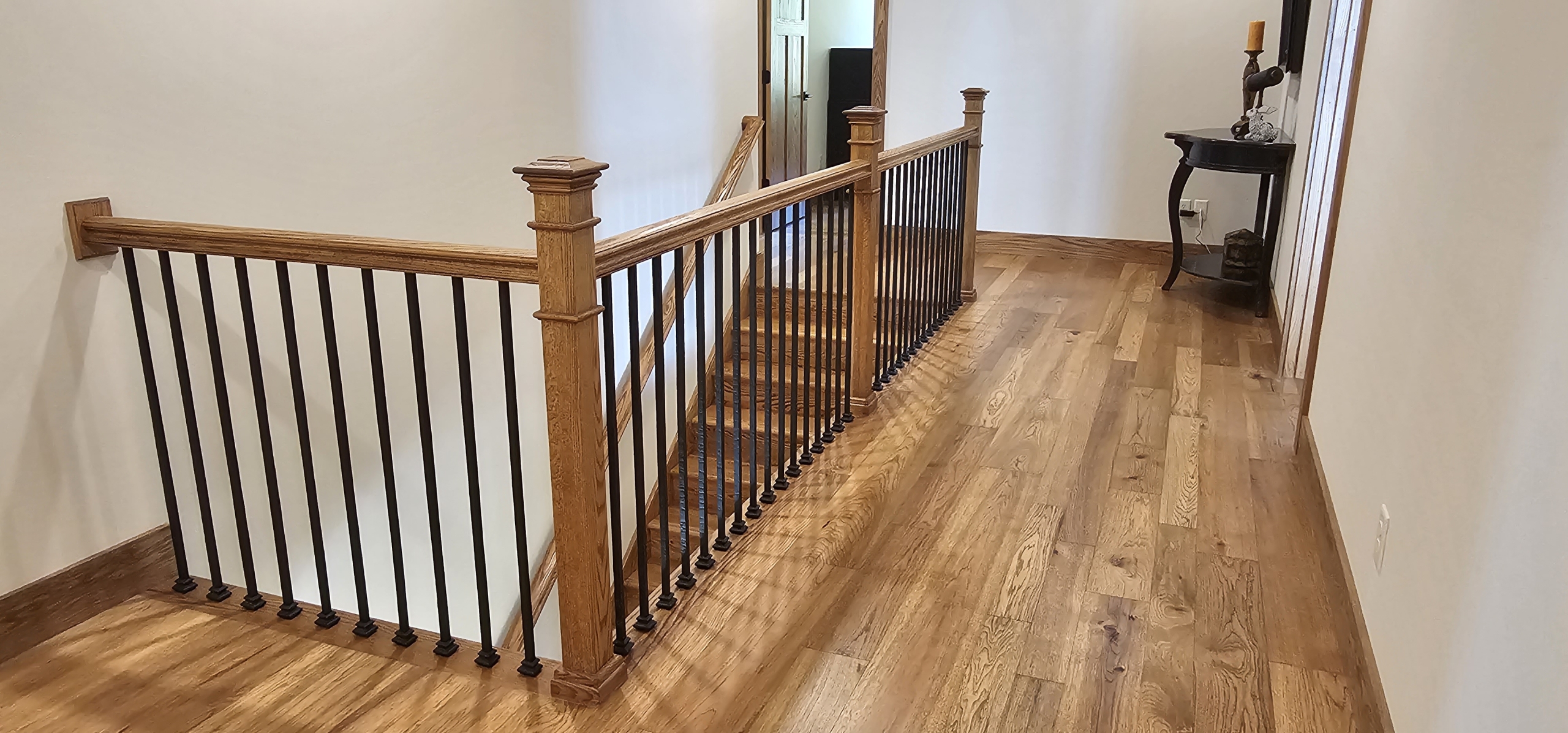 wood and metal railing around stairs descending to the first floor