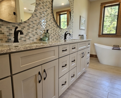 primary suite vanity and round mirrors