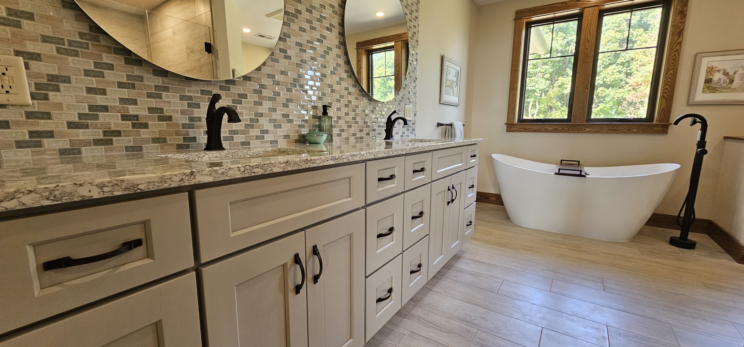 primary suite vanity and round mirrors