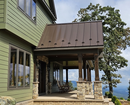 brown metal roof and green siding