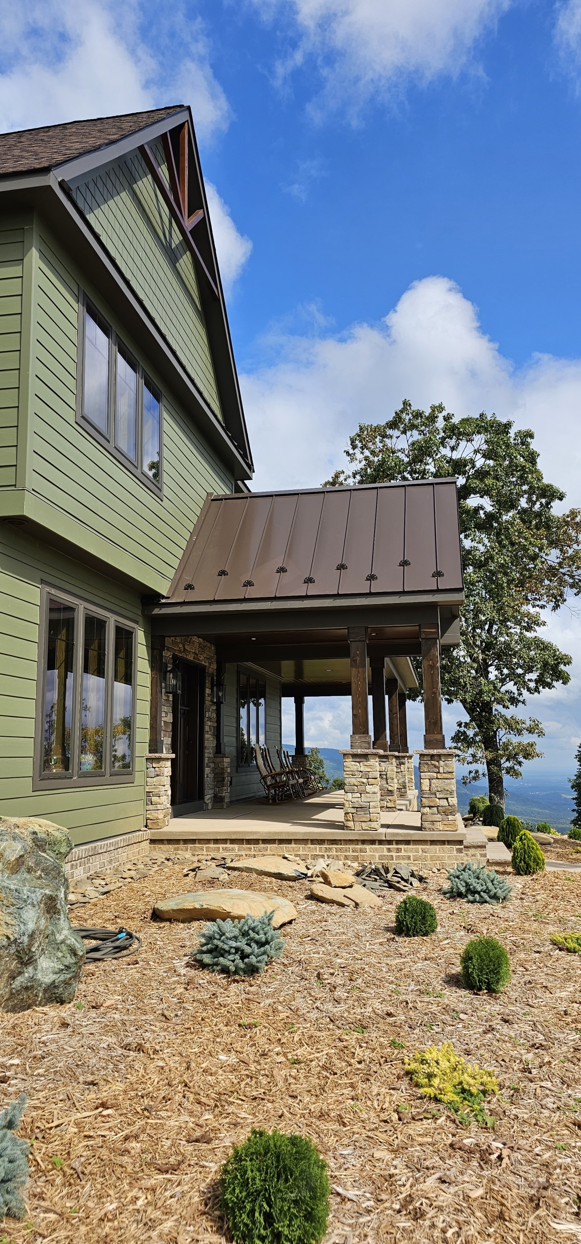 brown metal roof and green siding